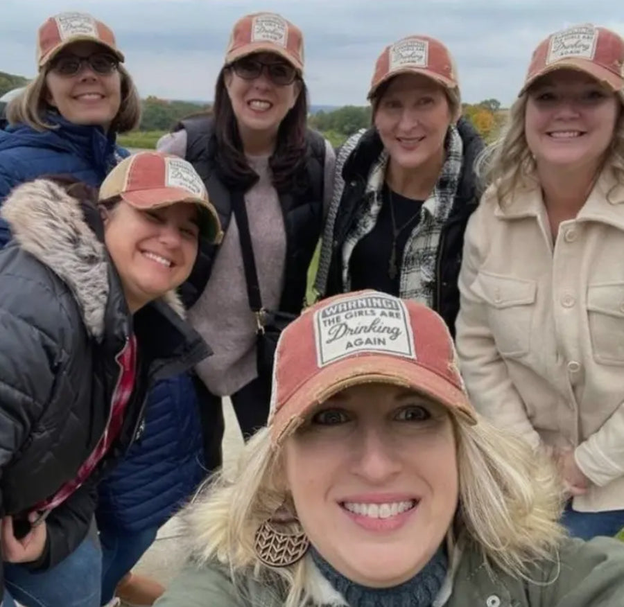 Warning the Girls are Drinking Again Distressed Trucker Hat